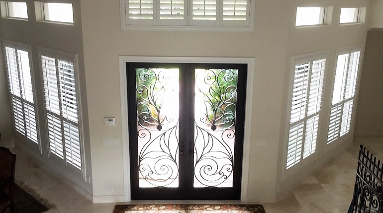 Southern California foyer with glass doors and plantation shutters